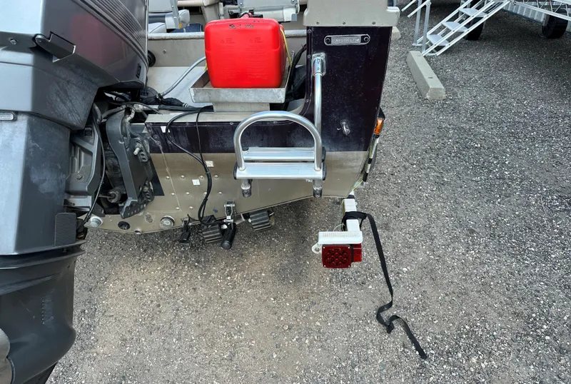 Slide: The Image of 1994 Lund 1850 Tyee boat rear view with motor and red fuel tank. - 17