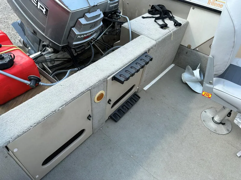 Slide: The Image of 1994 Lund 1850 Tyee boat interior with motor and seating. - 18