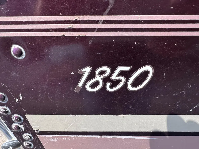 Slide: The Image of Close-up of 1994 Lund 1850 Tyee boat model number on dark surface. - 2