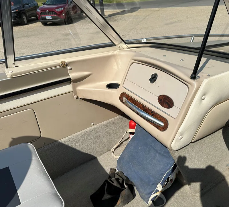 Slide: The Image of Interior of a 1994 Lund 1850 Tyee boat, featuring dashboard and seating area. - 7