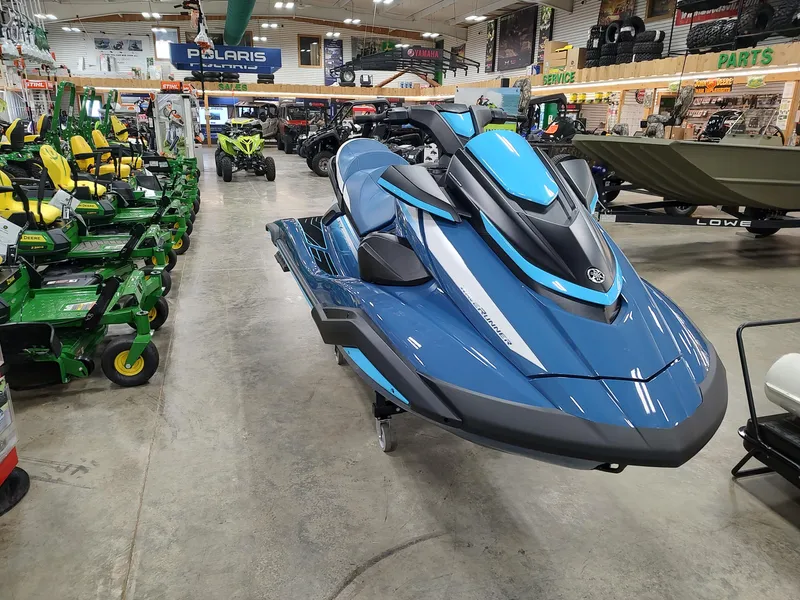 Slide: The Image of 2024 Yamaha WaveRunner FX Cruiser HO in showroom, surrounded by various vehicles and equipment. - 2