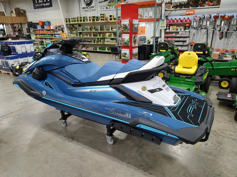 Slide: The Image of 2024 Yamaha WaveRunner FX Cruiser HO in showroom, blue color, side view. - 6