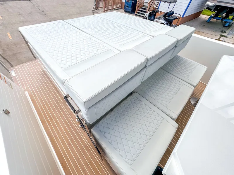 Slide: The Image of 2024 De Antonio Yachts D28 Open with luxurious white quilted seating and wooden deck. - 6