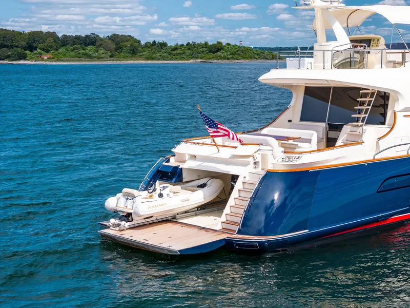 Slide: The Image of 2008 Mochi Craft Dolphin yacht with tender, anchored in scenic waters. - 12