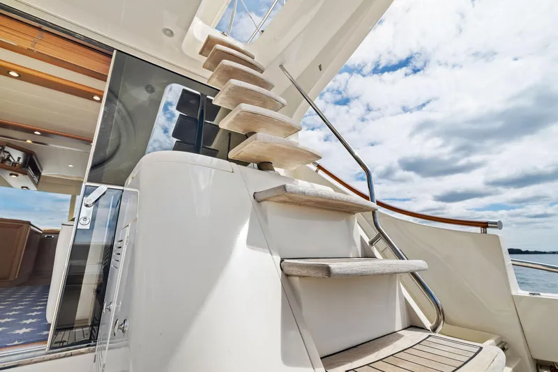 Slide: The Image of Staircase on 2008 Mochi Craft Dolphin yacht under a partly cloudy sky. - 17