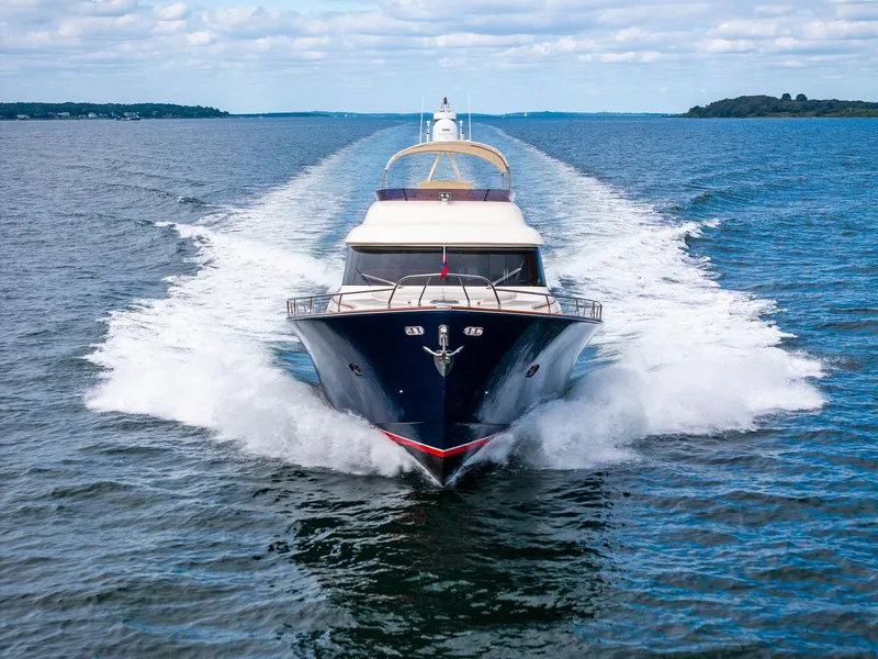Slide: The Image of Mochi Craft Dolphin 2008 yacht cruising on open water, front view. - 2