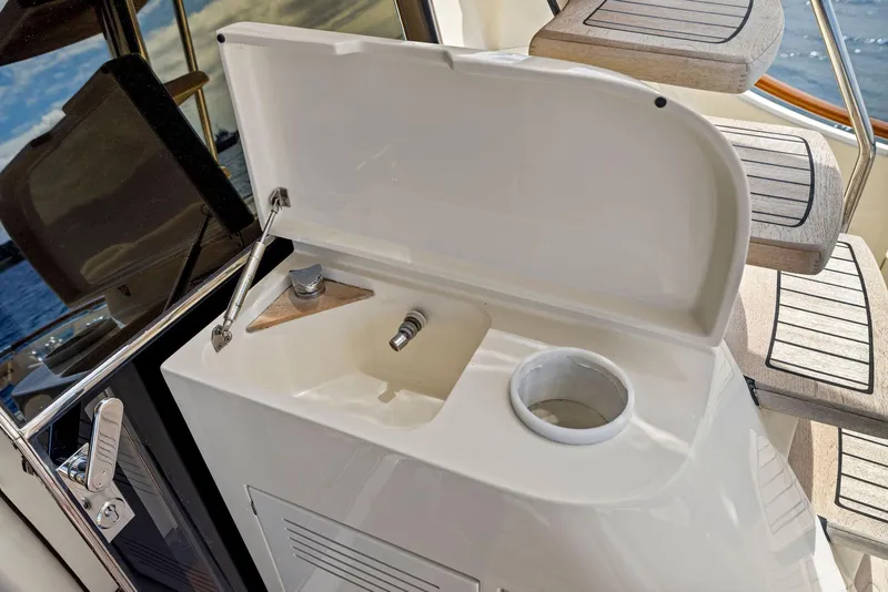 Slide: The Image of 2008 Mochi Craft Dolphin yacht sink area with open lid and steps. - 21