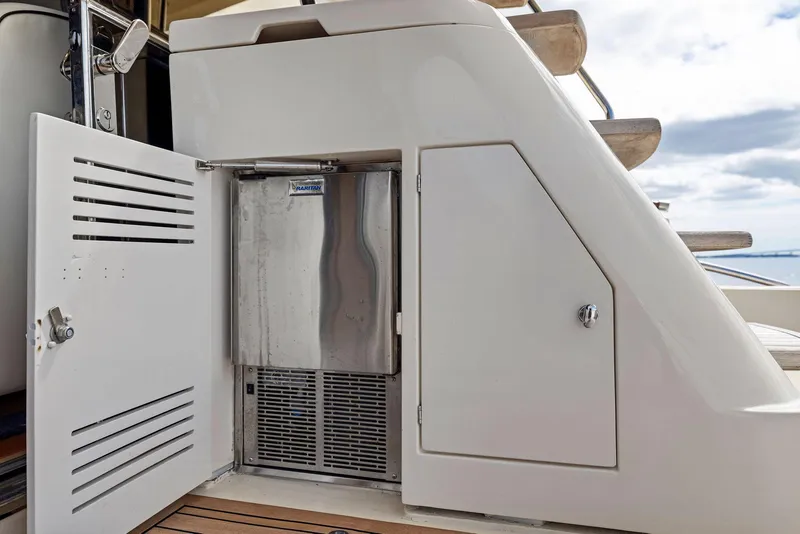 Slide: The Image of 2008 Mochi Craft Dolphin yacht with open storage compartment and stainless steel appliance. - 22