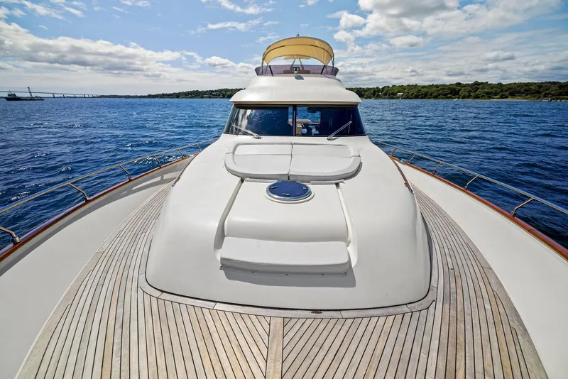 Slide: The Image of 2008 Mochi Craft Dolphin yacht on open sea, wooden deck, clear sky. - 23