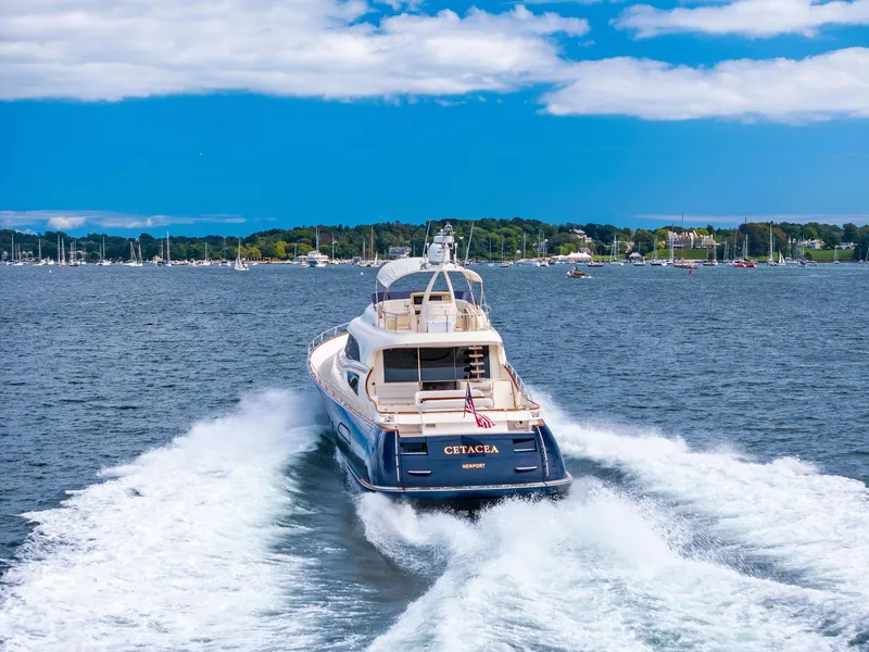 Slide: The Image of 2008 Mochi Craft Dolphin yacht cruising on open water under a clear blue sky. - 5