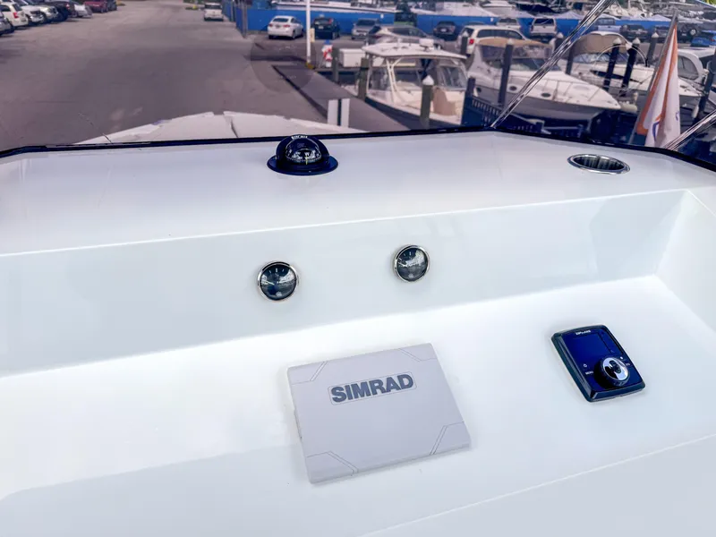 Slide: The Image of 2024 De Antonio Yachts D28 Open dashboard with Simrad navigation system and controls. - 10