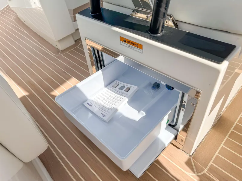 Slide: The Image of Open storage compartment on 2024 De Antonio Yachts D28 Open, featuring wooden deck flooring. - 15