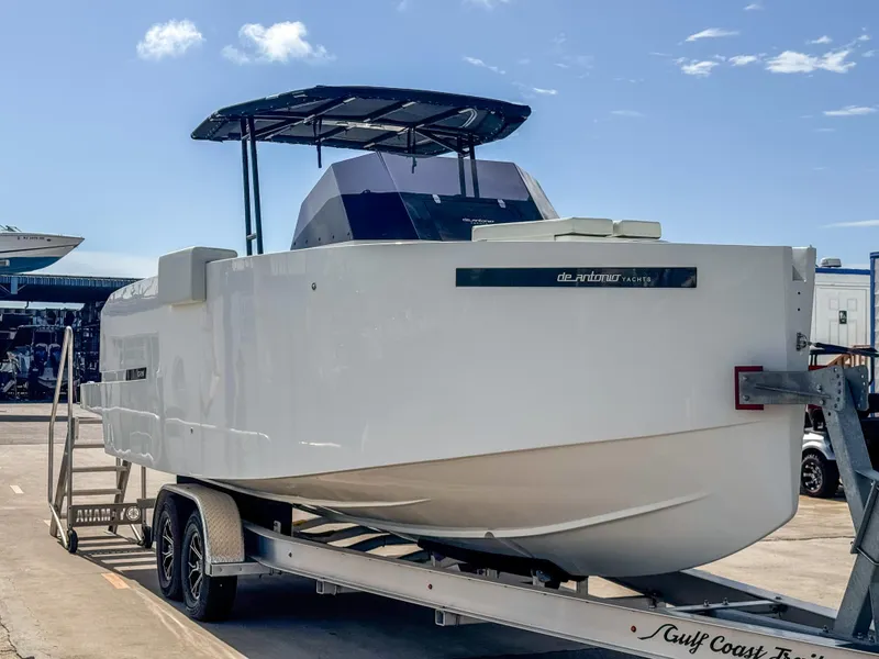 Slide: The Image of 2024 De Antonio Yachts D28 Open on trailer, sleek design under clear sky. - 2
