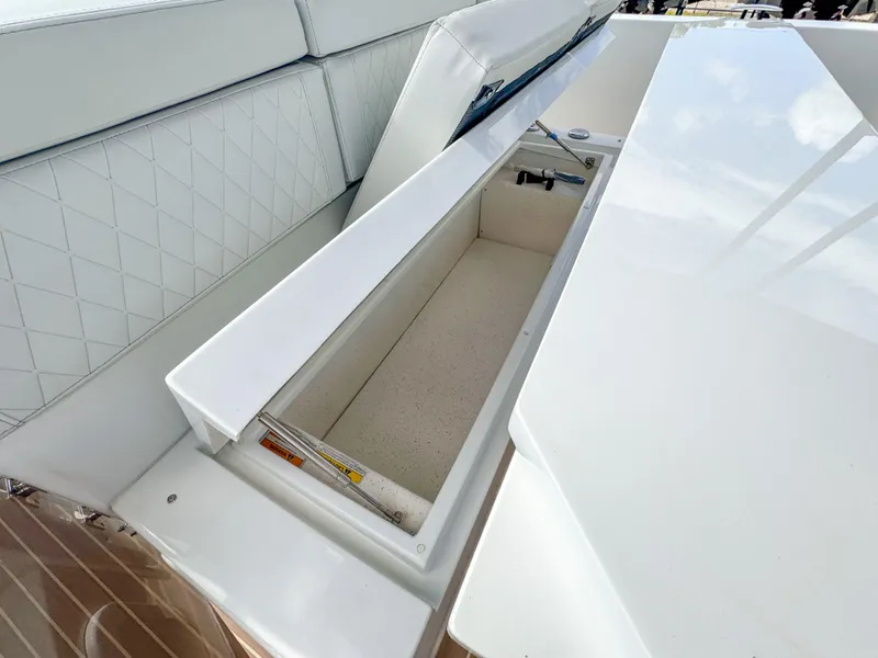 Slide: The Image of 2024 De Antonio Yachts D28 Open storage compartment with sleek white design and cushioned seating. - 8