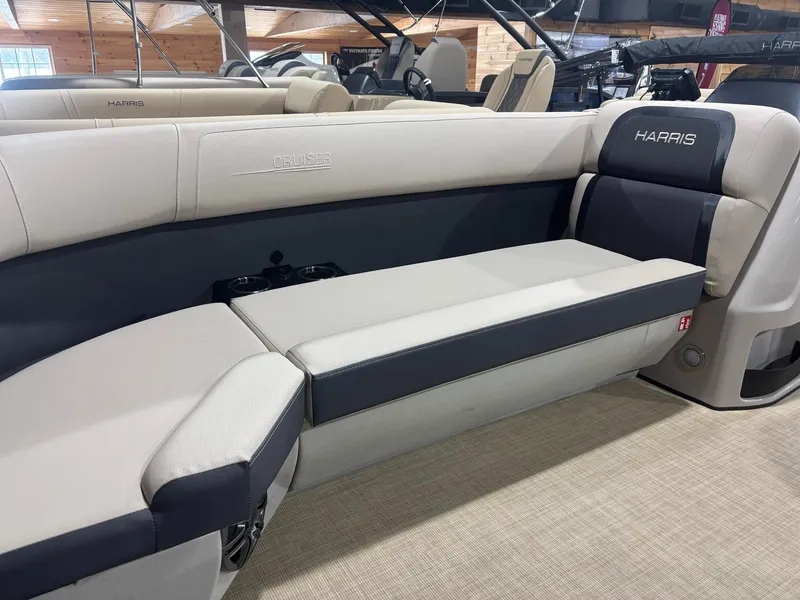 Slide: The Image of 2025 Harris CRUISER 230 SL boat interior with beige and black seating. - 3