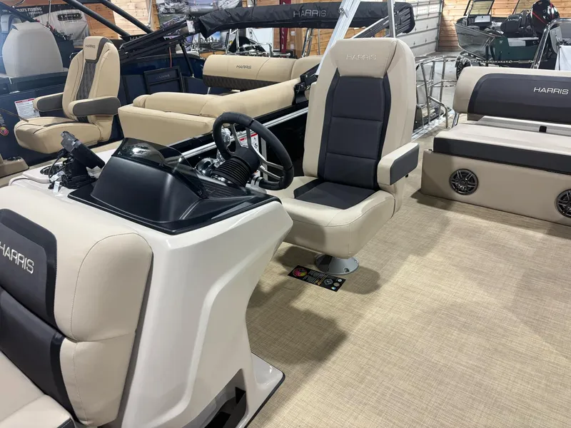 Slide: The Image of 2025 Harris CRUISER 230 SL boat interior with beige and black seating. - 4