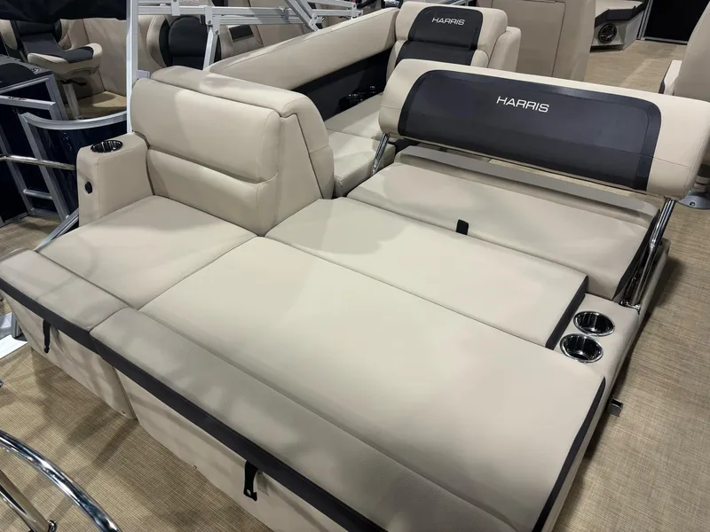 Slide: The Image of 2025 Harris CRUISER 230 SL boat interior with beige seating and cup holders. - 6