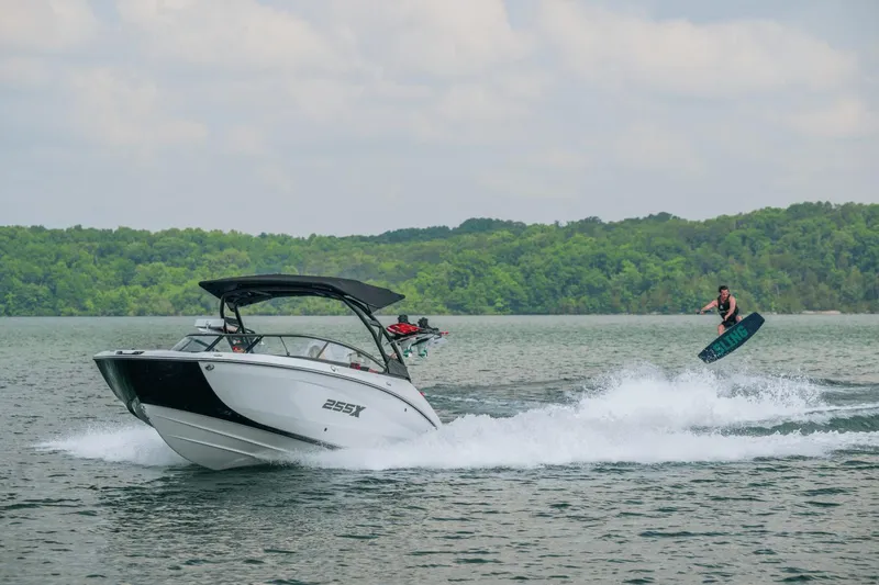 Slide: The Image of 2024 Yamaha Boats 255XD on lake with wakeboarder in action. - 12