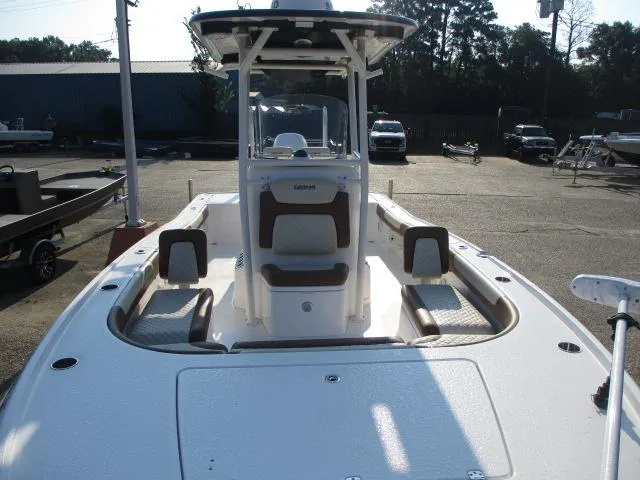 Slide: The Image of 2023 Caymas 26HB boat with center console, parked in a lot, showcasing seating and deck layout. - 3