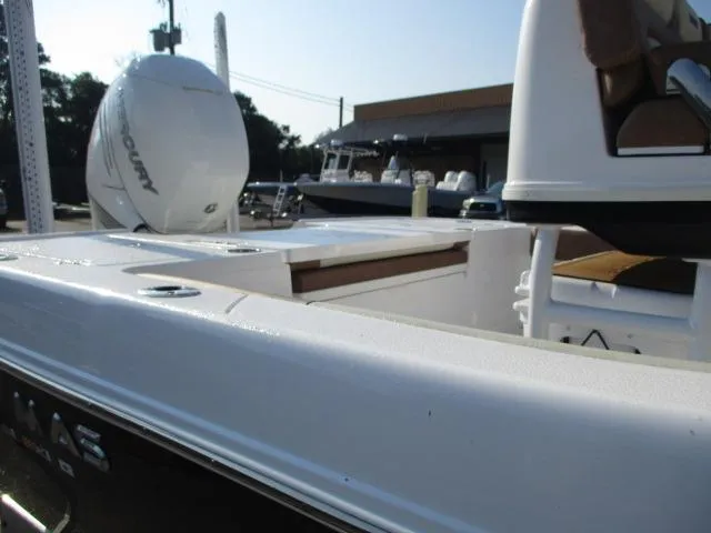 Slide: The Image of 2023 Caymas 26HB boat with Mercury engine, docked outdoors. - 4