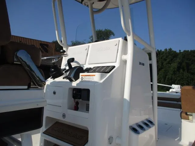 Slide: The Image of 2023 Caymas 26HB boat console with steering wheel and controls. - 5