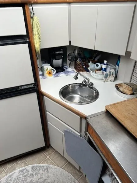 Slide: The Image of Compact kitchen in 1991 Carver 33 Aft Cabin boat with sink and appliances. - 5
