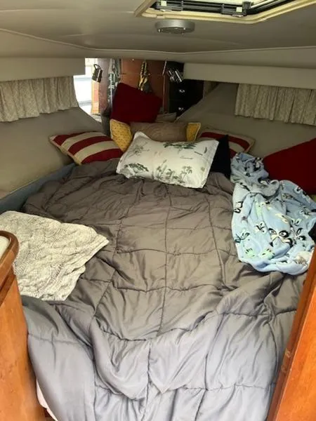 Slide: The Image of Cozy cabin interior of 1991 Carver 33 Aft Cabin with plush bedding and pillows. - 9