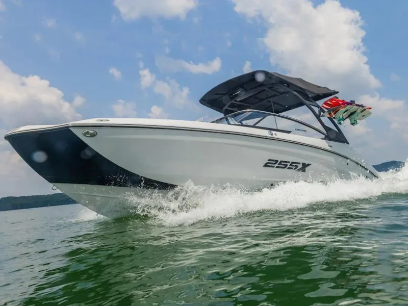 Slide: The Image of 2024 Yamaha Boats 255XD cruising on water under a clear sky. - 4