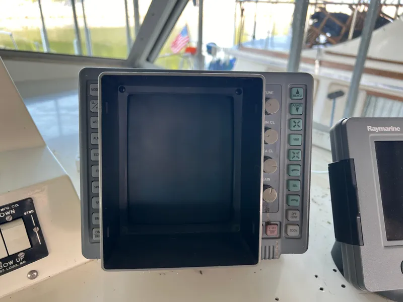 Slide: The Image of Control panel on a 1977 Bertram 42 Motor Yacht, featuring navigation equipment. - 11