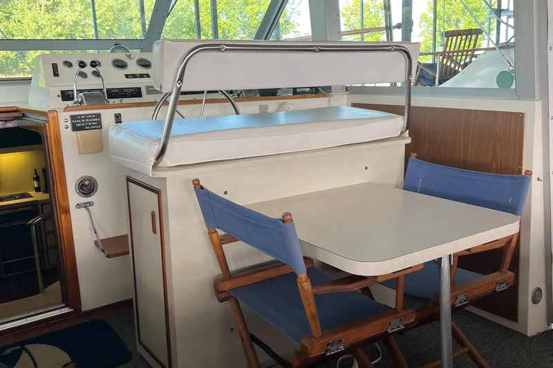 Slide: The Image of 1977 Bertram 42 Motor Yacht interior with dining area and helm station. - 12