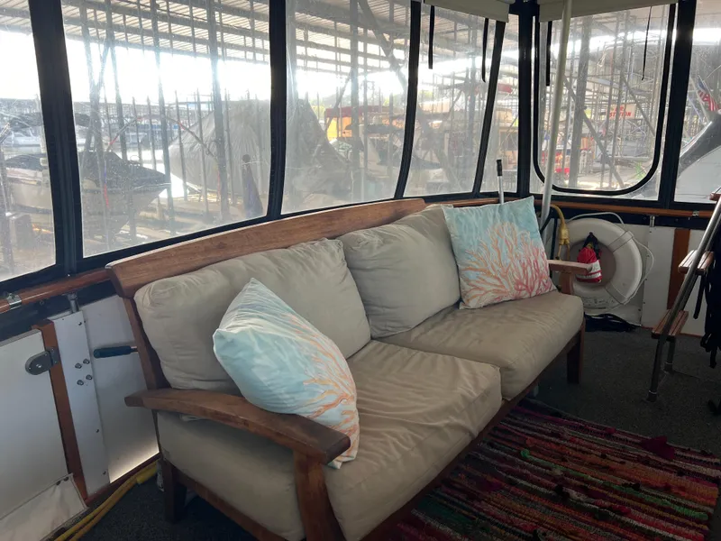 Slide: The Image of Cozy seating area on a 1977 Bertram 42 Motor Yacht with colorful pillows. - 14