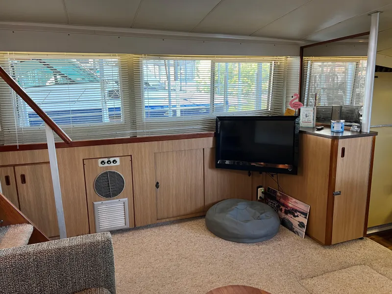 Slide: The Image of Interior of a 1977 Bertram 42 Motor Yacht with TV and seating area. - 16