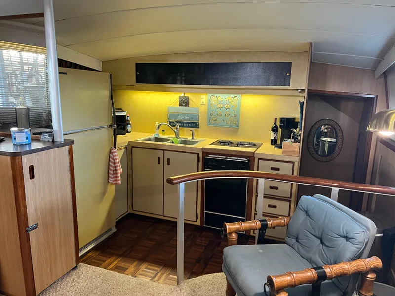 Slide: The Image of Interior of 1977 Bertram 42 Motor Yacht with kitchen and seating area. - 17