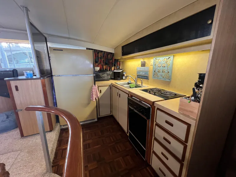 Slide: The Image of Interior of 1977 Bertram 42 Motor Yacht kitchen with appliances and wood cabinetry. - 18