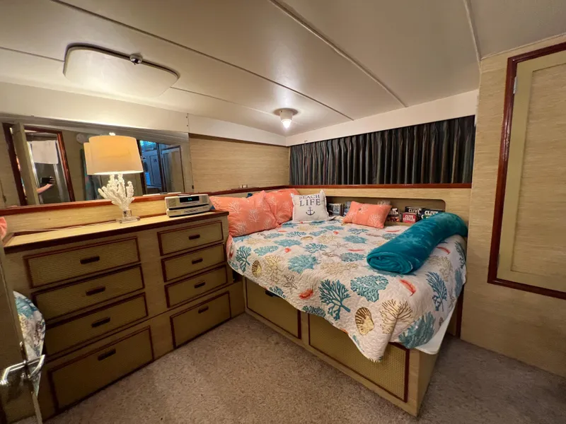 Slide: The Image of Cozy bedroom in 1977 Bertram 42 Motor Yacht with nautical decor and ample storage. - 25