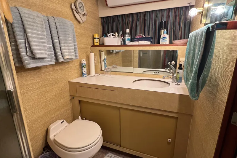 Slide: The Image of 1977 Bertram 42 Motor Yacht bathroom with sink, mirror, and toiletries. - 27