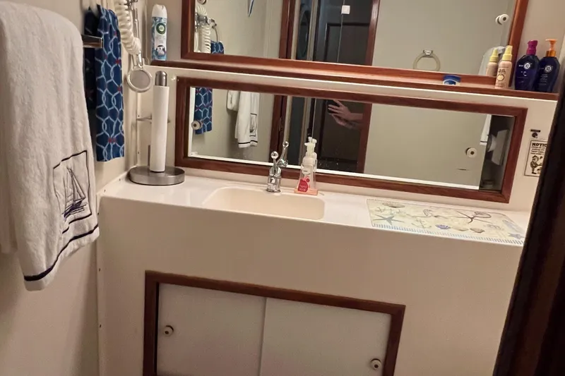 Slide: The Image of Bathroom interior of 1977 Bertram 42 Motor Yacht with sink and mirror. - 30