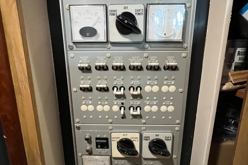 Slide: The Image of Control panel of a 1977 Bertram 42 Motor Yacht with switches and gauges. - 32