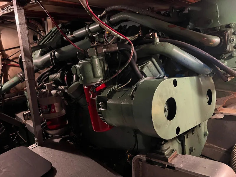 Slide: The Image of Engine room of a 1977 Bertram 42 Motor Yacht, showcasing complex machinery and components. - 36