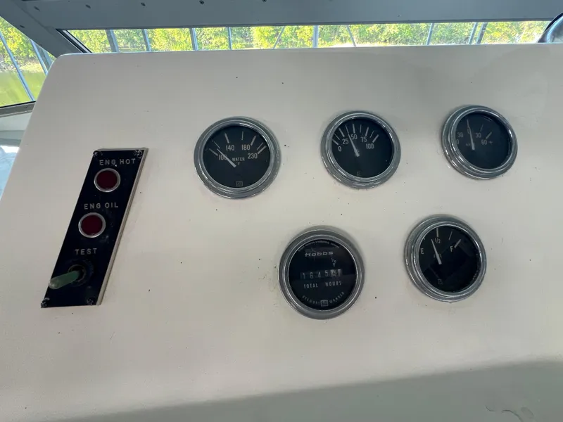 Slide: The Image of Dashboard of a 1977 Bertram 42 Motor Yacht with gauges and indicator lights. - 6