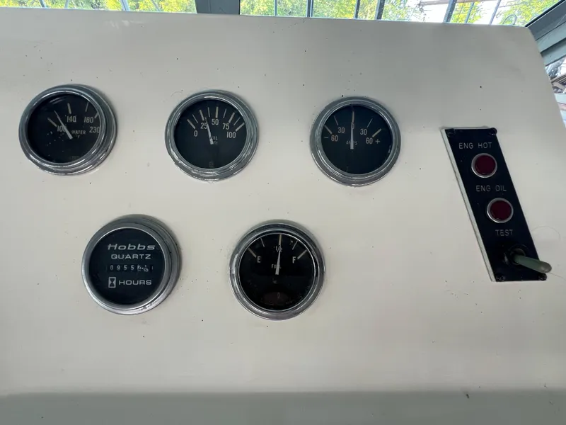 Slide: The Image of 1977 Bertram 42 Motor Yacht dashboard with gauges and engine indicators. - 7