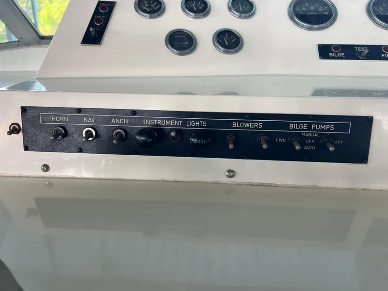 Slide: The Image of Control panel of a 1977 Bertram 42 Motor Yacht with switches and gauges. - 8