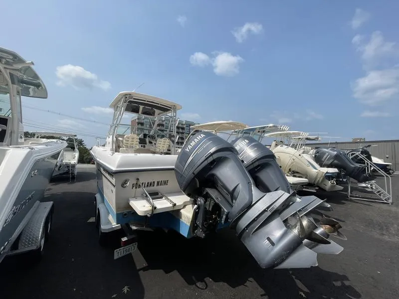 Slide: The Image of 2003 Grady-White 232 Gulfstream boat with dual Yamaha outboard motors in a marina. - 4