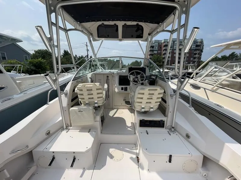 Slide: The Image of 2003 Grady-White 232 Gulfstream boat interior with dual seats and steering console. - 5