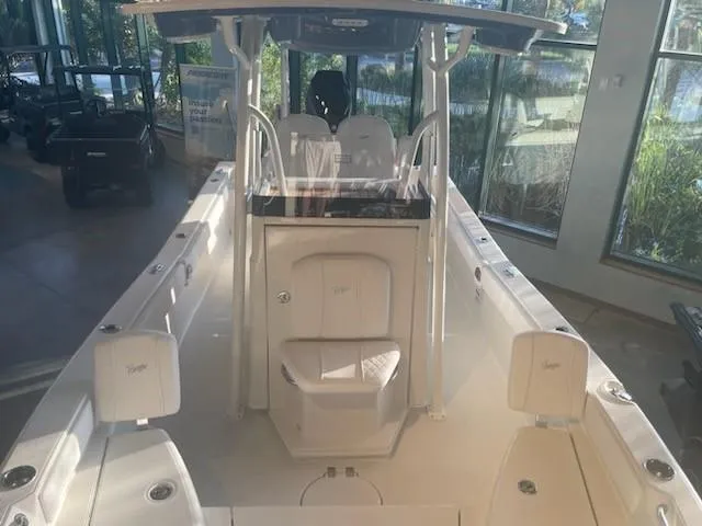Slide: The Image of 2024 Ranger 2660 Bay boat interior with seating and console in showroom. - 3