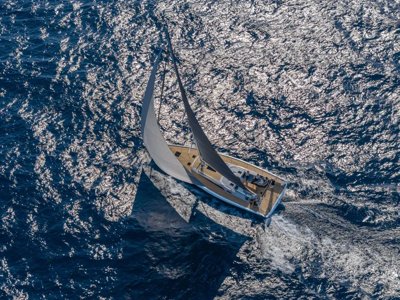 Slide: The Image of Aerial view of 2025 Grand Soleil 52 Performance yacht sailing on shimmering ocean waters. - 16