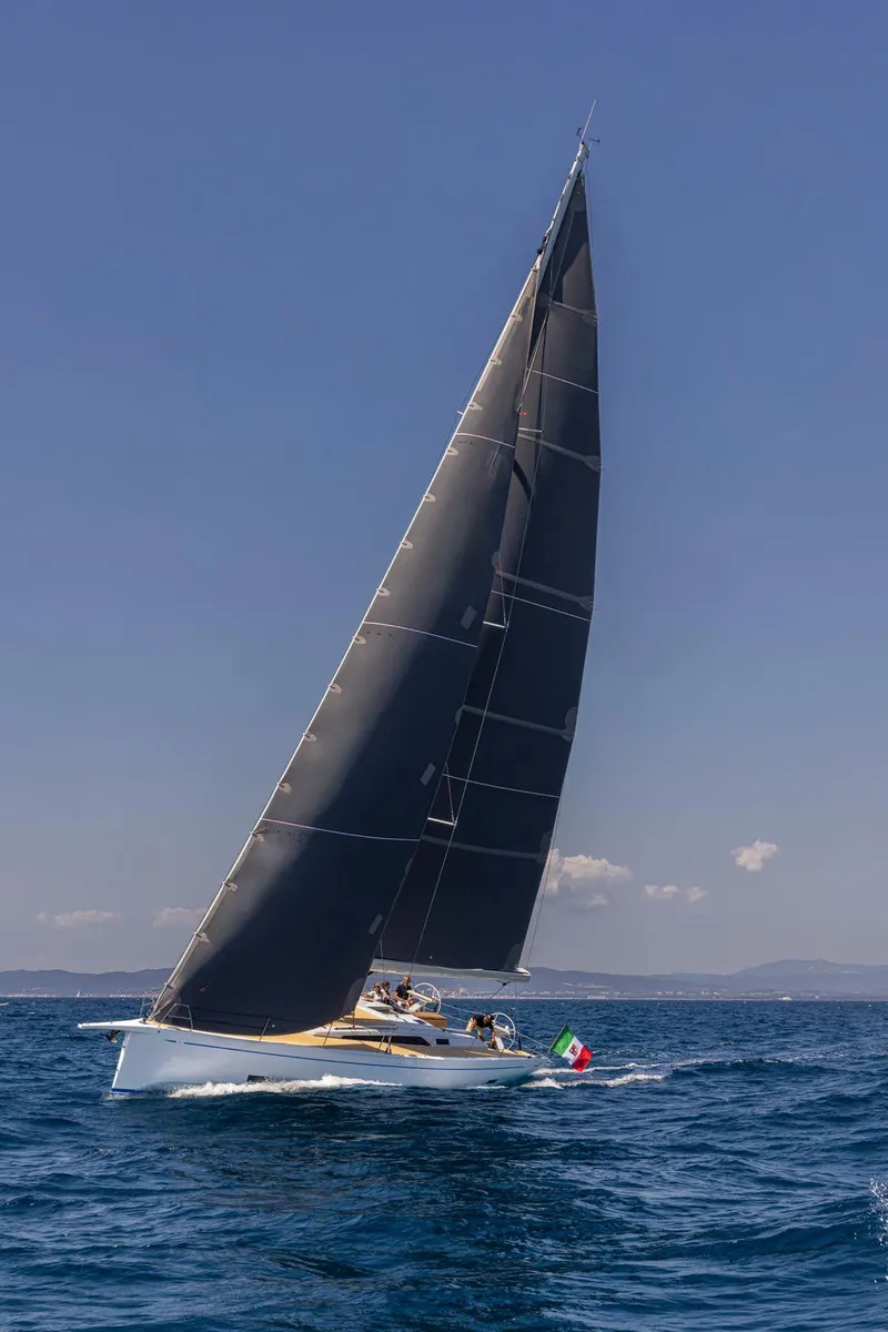 Slide: The Image of Grand Soleil 52 Performance 2025 sailing on open sea under clear blue sky. - 18