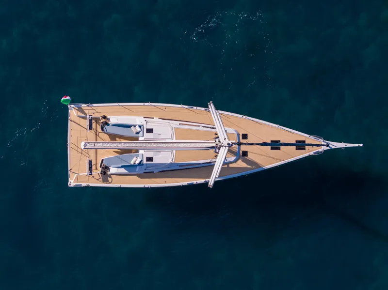 Slide: The Image of Aerial view of 2025 Grand Soleil 52 Performance yacht on clear blue water. - 2