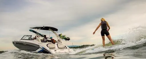 Slide: The Image of 2024 Yamaha AR195 boat with wakeboarder on water. - 9