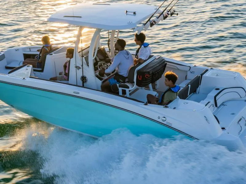 Slide: The Image of 2024 Yamaha Boats 252 FSH Sport cruising on water with passengers enjoying the ride. - 6